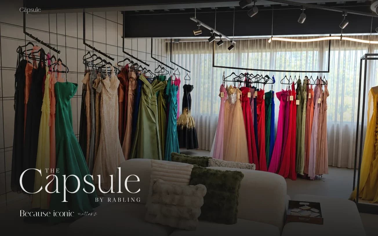 The Capsule home page: the showroom with racks of evening dresses and the The Capsule by Rabling logo